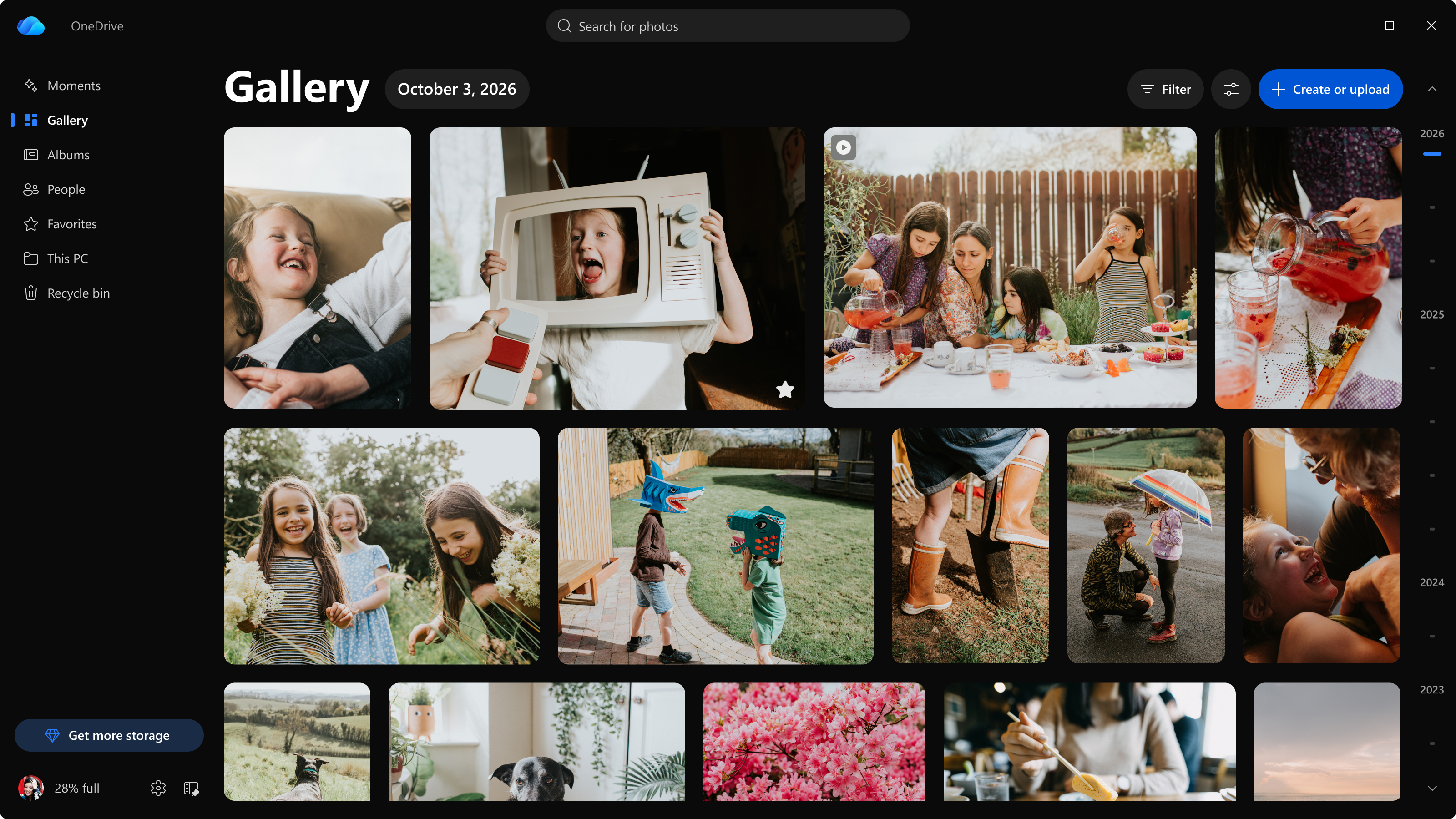 Screenshot showing OneDrive display your photos in a timeline, with navigation for Moments, Gallery, People, Albums, Favorites, photos stored on your PC, and the Recycle bin.