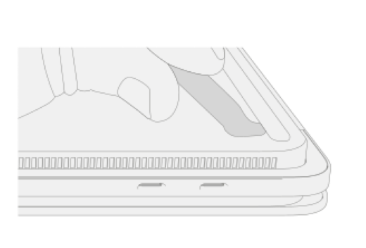 A spudger lifts the edge of a foot on a Surface Laptop Studio.