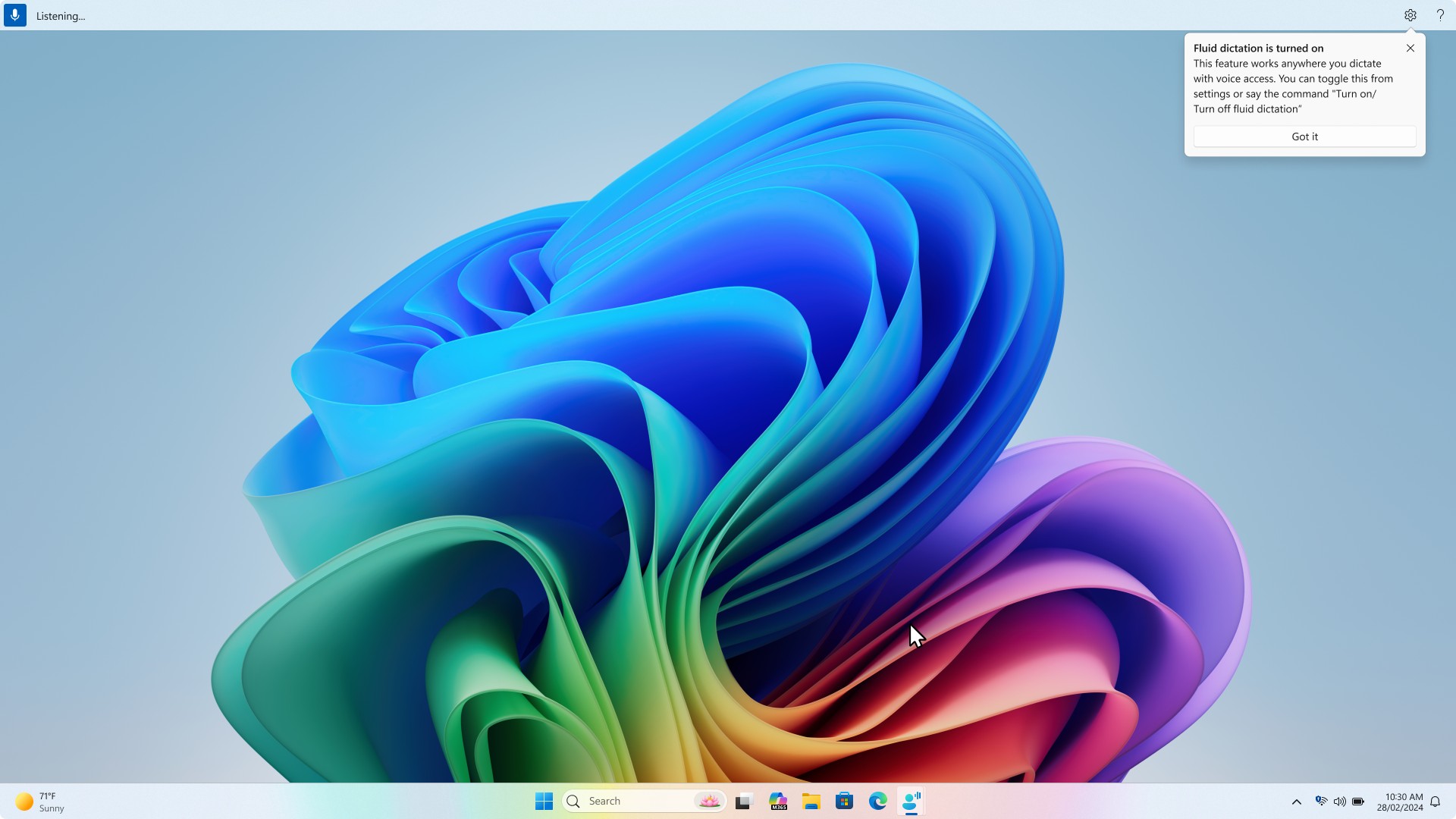 Screen showing a notification dialog titled “Fluid dictation is turned on.” The message explains that the feature works anywhere you dictate with voice access and can be toggled from settings or by saying “Turn on” or “Turn off fluid dictation.”
