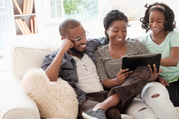 A family looking at a PC together