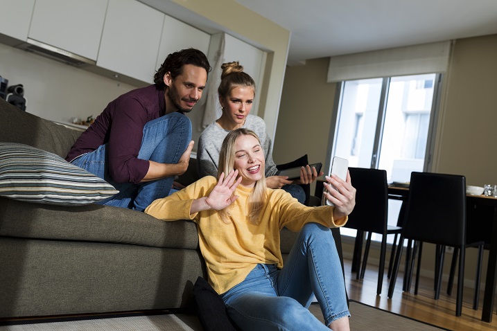 photo of friends having a video chat on a device.